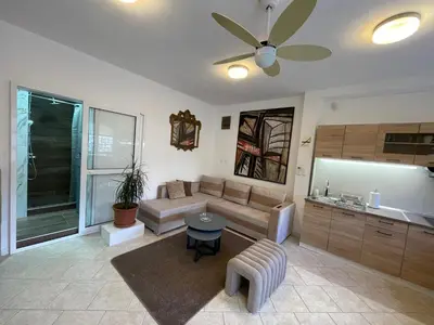 a living room with a couch and a table at Apartman Sahat kula in Podgorica
