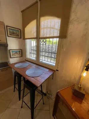 a wooden table in a room with a window at Apartman Sahat kula in Podgorica