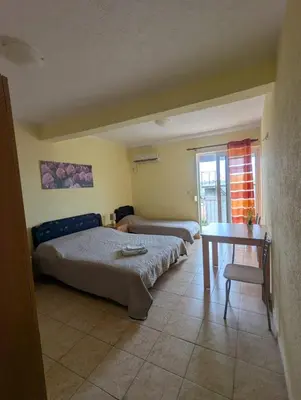 a living room with two beds and a table at Montana Mare in Sutomore