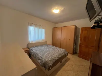 a small bedroom with a bed and a dresser at Montana Mare in Sutomore