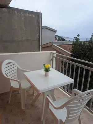 a white table and two chairs on a balcony at Montana Mare in Sutomore