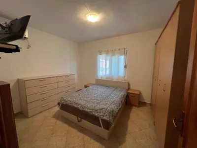 a bedroom with a bed and a dresser at Montana Mare in Sutomore