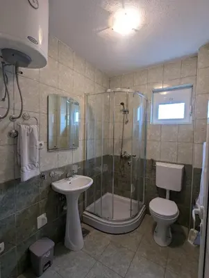 a bathroom with a shower and a toilet and a sink at Montana Mare in Sutomore