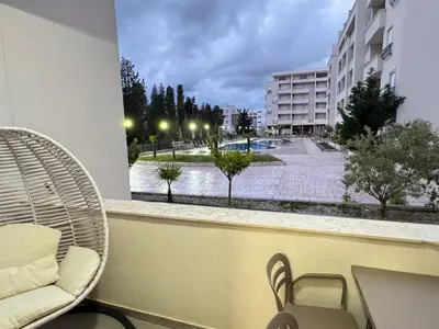 a balcony with a table and chairs and a building at ANI apartment 1 in Ulcinj