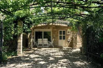 an archway with a table and chairs on a patio at Cremo House in Krimovice
