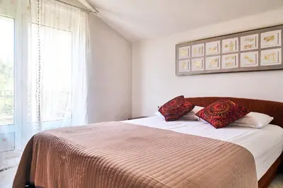 a bedroom with a bed with two pillows on it at Cremo House in Krimovice