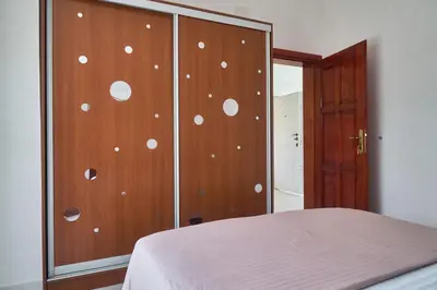 a bedroom with a wooden cabinet with white polka dots on it at Cremo House in Krimovice