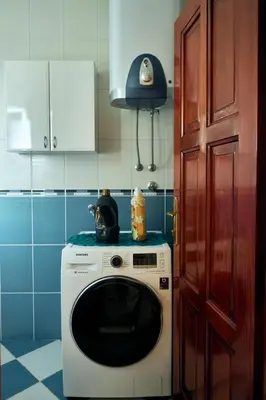 a kitchen with a washing machine and a door at Cremo House in Krimovice