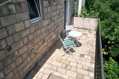 a patio with a table and a chair on a brick wall at Cremo House in Krimovice
