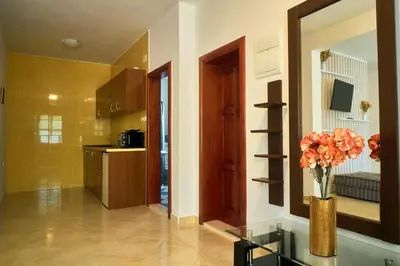 a kitchen with a vase of flowers on a glass table at Cremo House in Krimovice