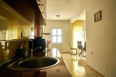 a kitchen with a sink and a living room at Cremo House in Krimovice