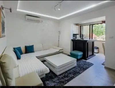 a living room with a couch and a table at Holiday 1 in Dobrota