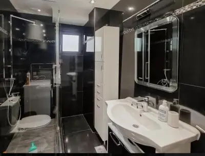 a bathroom with a sink and a shower and a toilet at Holiday 1 in Dobrota
