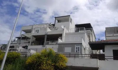 a white building with balconies on the side of it at Apartment Boksi in Ulcinj