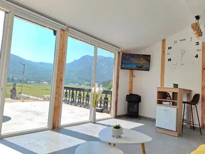 a living room with a view of a mountain at Kutak prirode in Njeguši