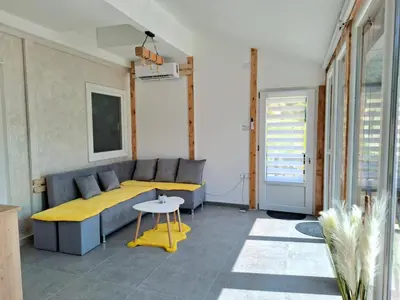 a living room with a couch and a table at Kutak prirode in Njeguši