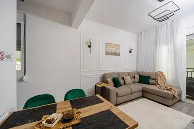 a living room with a couch and a table at Alpha Neo in Bar
