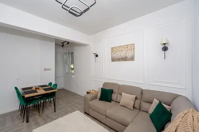 a living room with a couch and a table at Alpha Neo in Bar