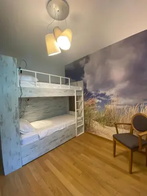 a room with two bunk beds and a chair at Ekaterina1-KS in Becici