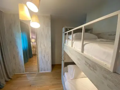 a bedroom with a bunk bed and a mirror at Ekaterina1-KS in Becici
