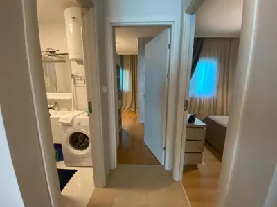 a bathroom with a washing machine and a washer at Ekaterina1-KS in Becici