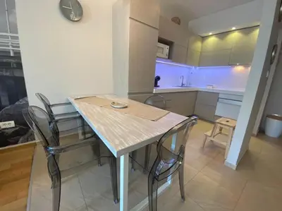 a kitchen with a table and chairs in a room at Ekaterina1-KS in Becici