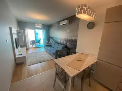 a living room with a table and a couch at Ekaterina1-KS in Becici