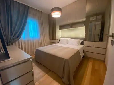 a bedroom with a large bed and a television at Ekaterina1-KS in Becici