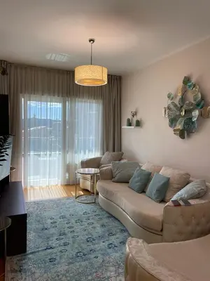 a living room with a couch and a table at Ekaterina2BD in Becici