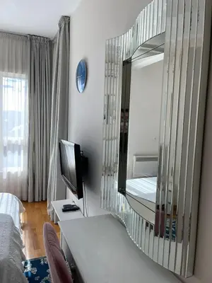 a living room with a mirror and a television at Ekaterina2BD in Becici