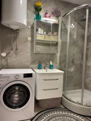 a bathroom with a washing machine and a shower at Ekaterina2BD in Becici