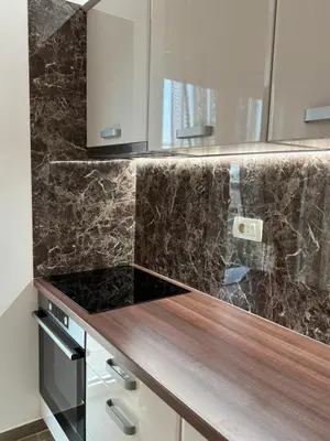 a kitchen with marble counter tops and wooden counter top at Ekaterina3VA in Becici