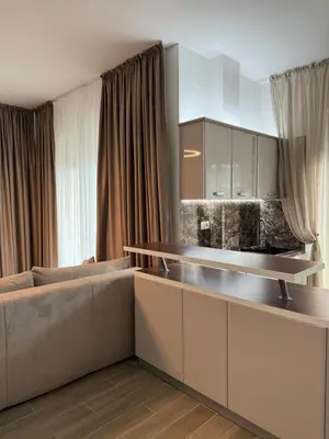 a living room with a couch and a kitchen at Ekaterina3VA in Becici