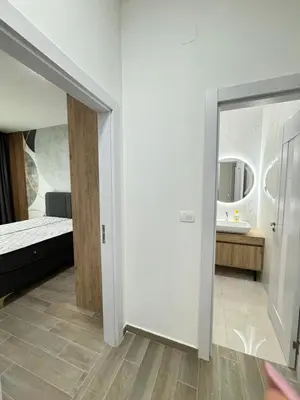 a room with a bed and a mirror at Ekaterina3VA in Becici