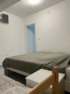 a small bedroom with a bed and a window at Nelaa in Sutomore