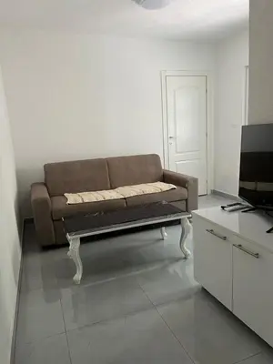 a living room with a couch and a tv at Nelaa in Sutomore