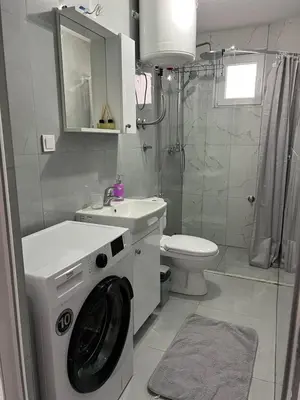 a bathroom with a washing machine and a toilet at Nelaa in Sutomore