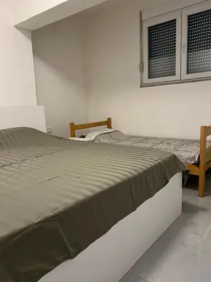 a bedroom with two beds and a window at Nelaa in Sutomore