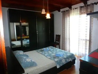 a bedroom with a bed and a large mirror at Apartment Djakonovic Mladen in Ulcinj