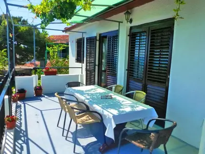 a table and chairs on the balcony of a house at Apartment Djakonovic Mladen in Ulcinj