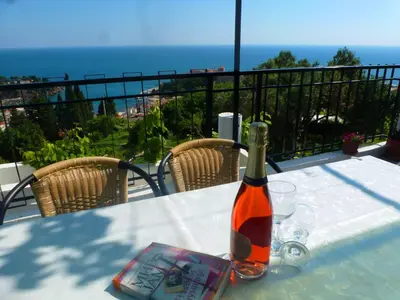 a bottle of wine sitting on top of a table at Apartment Djakonovic Mladen in Ulcinj