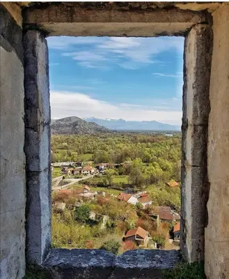 a view from an old window of a village at Apartman Žabljak Crnojevića in Žabljak