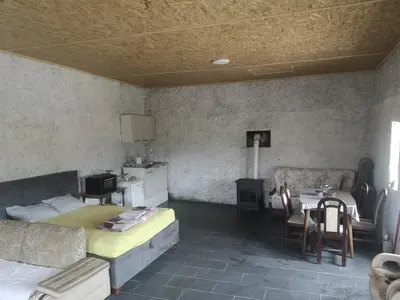 a bedroom with a bed and a table and chairs at Apartman Žabljak Crnojevića in Žabljak