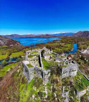 an old castle with a lake in the background at Apartman Žabljak Crnojevića in Žabljak
