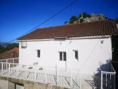 a white house with a red roof at Apartman Žabljak Crnojevića in Žabljak
