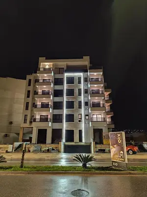 a large apartment building at night with a parking lot at B1 first line apartments in Bar, Susanj