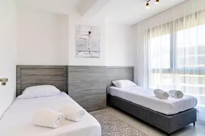 a bedroom with two beds and a window at B1 first line apartments in Bar, Susanj