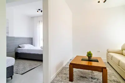 a living room with a couch and a table at B1 first line apartments in Bar, Susanj
