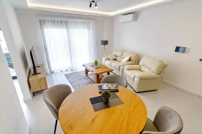 a living room with a table and a couch at B1 first line apartments in Bar, Susanj