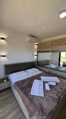 a bedroom with a large bed with towels on it at Rasi Sea Side Villa in Ulcinj